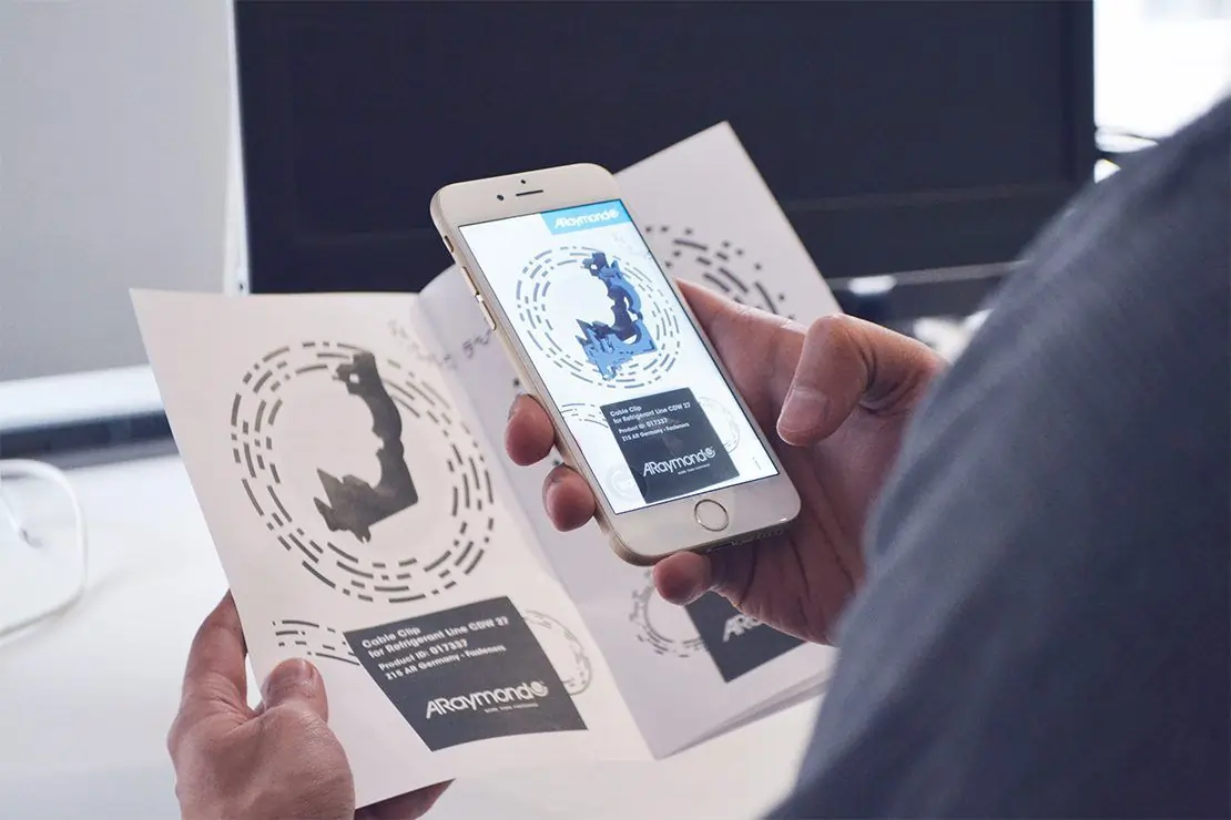 A phone scanning a paper for an AR experience.