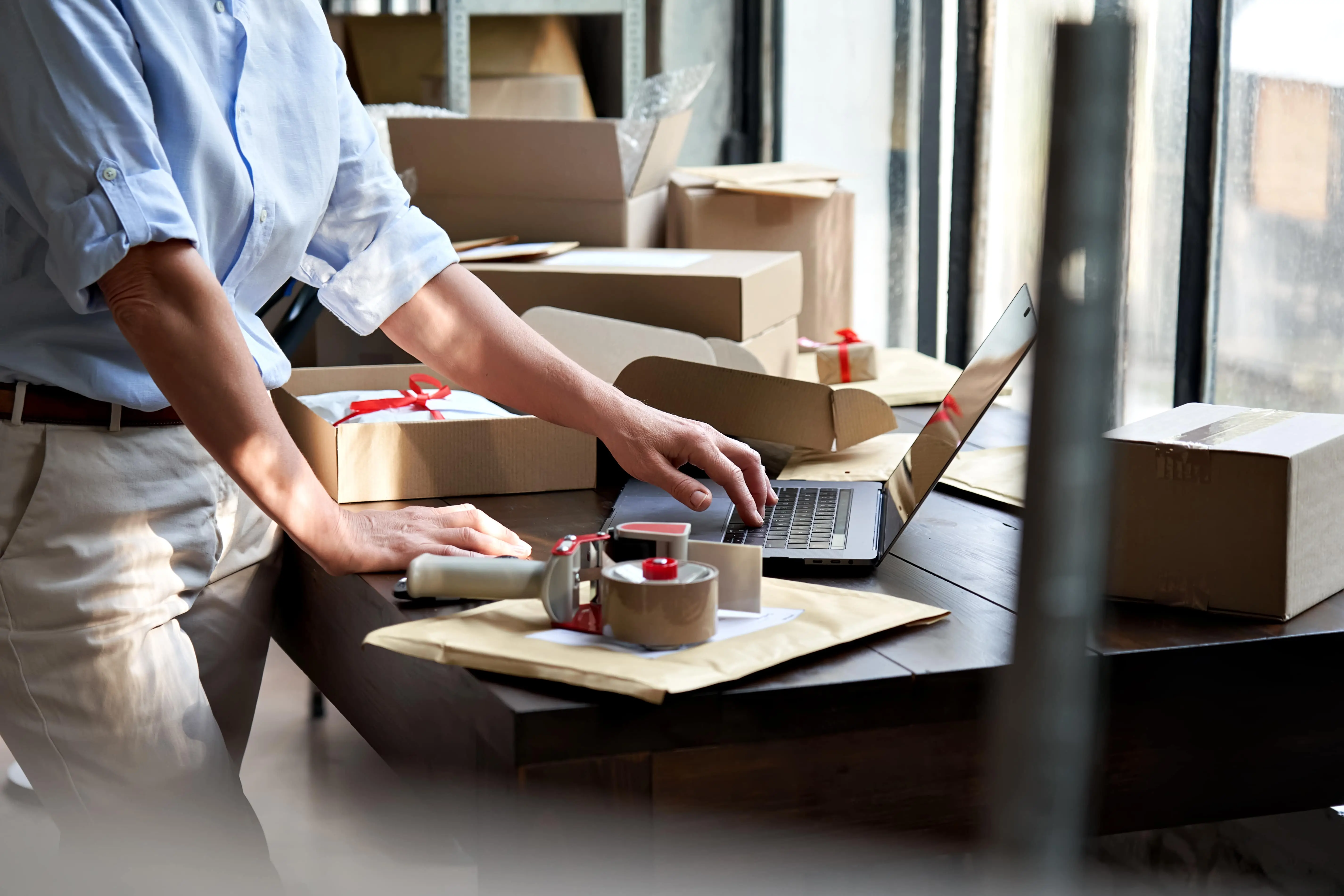 An entrepreneur checking on his E-COMMERCE platform and checking deliveries.